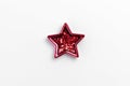 Christmas five pointed red star on white background. Christmas glittery decoration Royalty Free Stock Photo