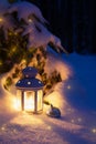 Christmas flashlight with a toy in the snow at night in the forest