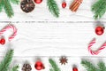 Christmas flat lay background. frame made of fir branches, decorations, berries, candy and pine cones. top view Royalty Free Stock Photo