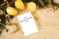 Christmas flat lay for a book presentation: book with blank cover settled with three lit candles , white organza and gold satin Royalty Free Stock Photo