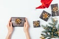 Christmas flat lay composition female hands holding a gift box