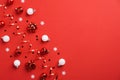 Christmas flat lay composition. Red festive decorations, white baubles and tinsel on red background. Flat lay, top view, copy Royalty Free Stock Photo