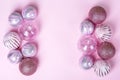 Christmas flat lay composition. Set of Christmas pink decorations, shiny balls on pastel background. Mock up for new year gretting