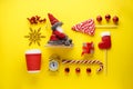 Christmas flat lay composition. Christmas sweets, gift, toys, Santa in a sleigh, an alarm clock with a cool down time and a cup on
