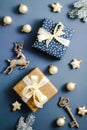 Christmas flat lay composition. Vintage Christmas gifts and decorations on blue table top view
