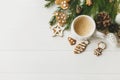 Christmas flat lay with gingerbread cookies, coffee, pine cones and branches on white table