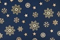 Christmas flat lay with golden snowflake and star ornaments on blue background Royalty Free Stock Photo