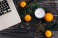 Christmas flat lay of laptop and green branches and oranges and Royalty Free Stock Photo