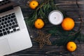 Christmas flat lay of laptop and green branches and oranges and Royalty Free Stock Photo