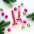 Christmas flat lay of lollipops, balls and fir branches on white background