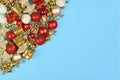 Christmas flat lay with red and golden ornaments like red tree baubles, gift boxes or golden bells in corner of blue background Royalty Free Stock Photo