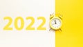 Christmas flat lay 2022. Retro style yellow clock in happy xmas midnight. Countdown to new year on happy xmas yellow Royalty Free Stock Photo