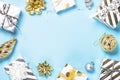 Christmas flatlay background - silver and gold decorations on blue. Royalty Free Stock Photo