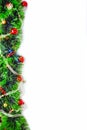 Green tinsel with red and gold balls on a white background Royalty Free Stock Photo