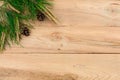 Christmas flatlay on a rustic wooden background: green pine needles with cones. Royalty Free Stock Photo