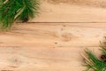 Christmas flatlay on a rustic wooden background: green pine needles with cones. Royalty Free Stock Photo