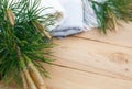 Christmas flatlay on a rustic wooden background: green pine needles with cones, warm woolen things in white and blue. New year`s c Royalty Free Stock Photo