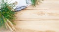 Christmas flatlay on a rustic wooden background: green pine needles with cones, warm woolen things in white and blue. New year`s Royalty Free Stock Photo