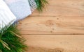 Christmas flatlay on a rustic wooden background: green pine needles with cones, warm woolen things in white and blue. New year`s c Royalty Free Stock Photo