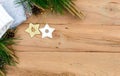 Christmas flatlay on a rustic wooden background: green pine needles with cones, wooden decorations in the shape of stars, Royalty Free Stock Photo