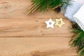 Christmas flatlay on a rustic wooden background: green pine needles with cones, wooden decorations in the shape of stars, Royalty Free Stock Photo