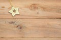 Christmas flatlay on a wooden background in rustic style: decorations made of wood in the shape of a star, spruce. Royalty Free Stock Photo