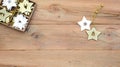 Christmas flatlay on a wooden background in rustic style: decorations made of wood in the shape of a star, spruce. Royalty Free Stock Photo