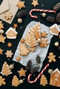 Christmas flatley layout with cookies and a christmas tree. Composition with ginger cookies and cones on a dark background Royalty Free Stock Photo