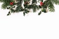 Christmas floral frame, web banner. Border of red holly berries and green fir tree branches isolated on white table Royalty Free Stock Photo