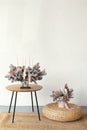 Christmas flower composition of spruce branches, cotton flowers, cinnamon, Christmas glass balls, ribbons and gray Ceramic owl for