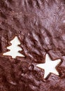 Christmas food background with cut out chocolate raw dough in form of Christmas trees and stars. Flat lay Holiday baking concept,