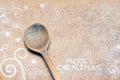 Christmas food background with spoon and flour. Merry Christmas inscription