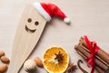 Christmas food background with spoon in santa hat, cinnamon, nuts and dried orange Royalty Free Stock Photo