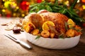 Christmas food. Baked turkey garnished with potato, oranges and cranberries