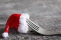 Christmas food menu abstract background with fork and santa claus hat on table Royalty Free Stock Photo