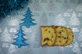 Christmas food photography picture with traditional Italian panettone cake with blue tinsel and glitter tree decorations