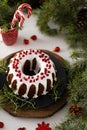 Christmas food. Round pie with white icing. Cupcake with a hole in the middle with pomegranate. Spruce branches on the Royalty Free Stock Photo