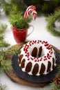 Christmas food. Round pie with white icing. Cupcake with a hole in the middle with pomegranate. Spruce branches on the Royalty Free Stock Photo