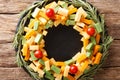 Christmas food: a wreath of pesto cheese, cheddar, mimolette wit Royalty Free Stock Photo