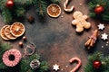Christmas frame or background with gingerbread cookies, spices, fir tree Royalty Free Stock Photo