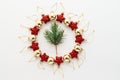 Christmas frame. Christmas balloons, garlands, red and gold decorations, Christmas candies and fir branches on a white