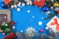 Christmas frame on blue background with gifts and decorations with copy space and snow Royalty Free Stock Photo