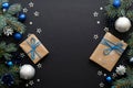 Christmas frame with blue and sliver modern decorations, baubles, fir tree branches, gift boxes on dark black background. Elegant Royalty Free Stock Photo