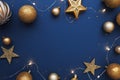 Christmas frame border with golden balls, stars, ribbon on blue background Royalty Free Stock Photo