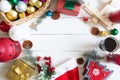 Christmas frame or border with a large assortment of christmas prop, decorations, balls, gifts and candles on a white wooden backg Royalty Free Stock Photo