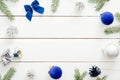 Christmas frame border made of blue and silver decorations, balls, gift boxes, pine tree branch on white wooden background. Flat Royalty Free Stock Photo