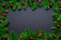 Christmas frame border wirh fir branch and baubles on black background