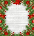 Christmas frame decorations with poinsettia, fir tree, holly berries and decorative golden ribbons on light wooden background. Royalty Free Stock Photo