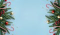 Christmas frame of fir branches and baubles on blue background, top view Royalty Free Stock Photo
