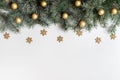 Christmas frame with fir branches, golden snowflakes and balls on a white background